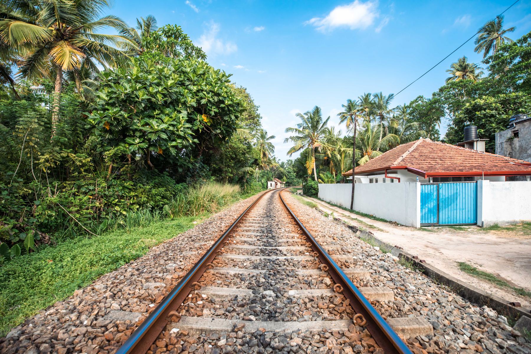 The coastal railway line running past the villa between palm trees